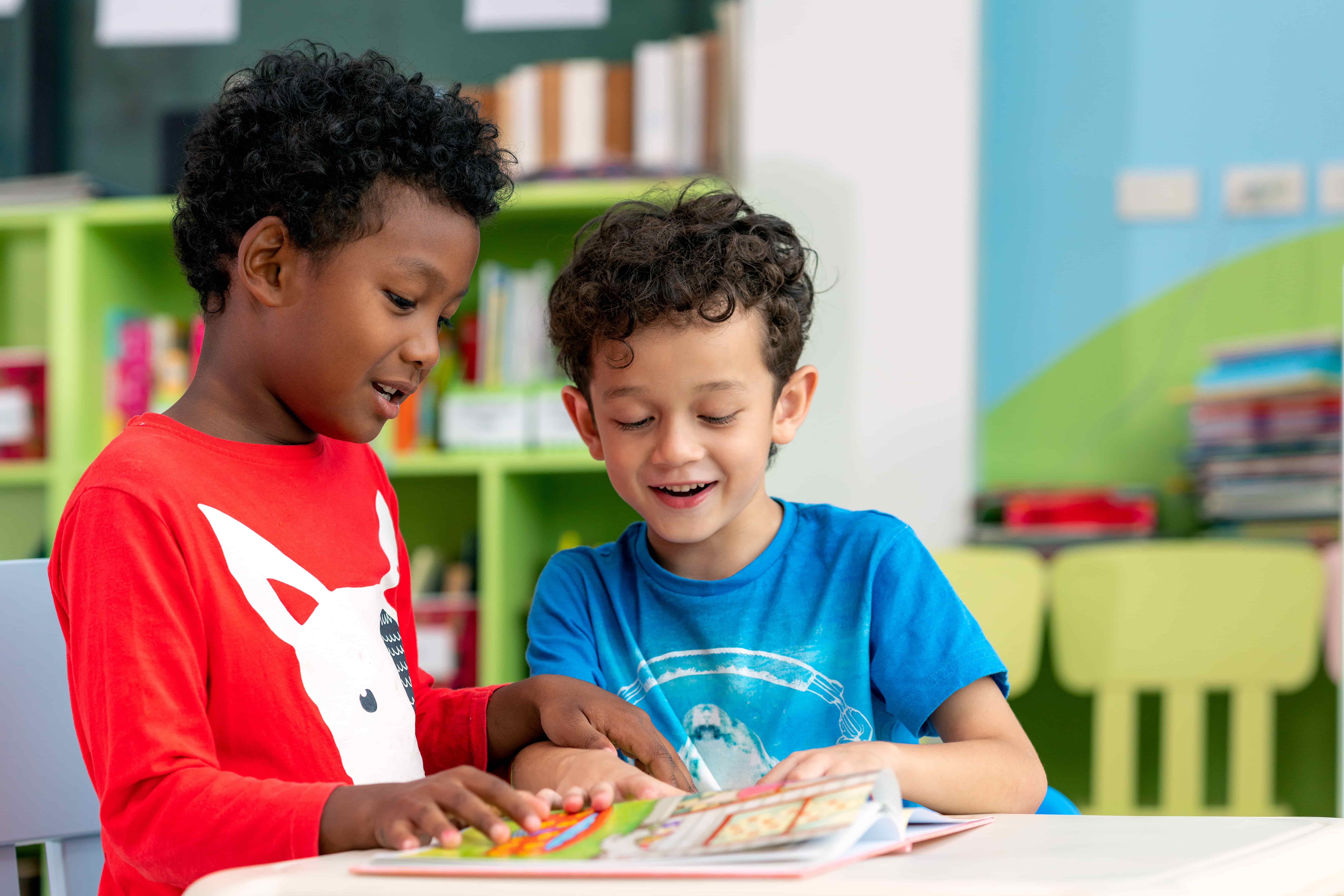 Teacher guiding young children in a painting activity during creative learning time